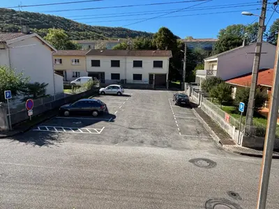 an empty parking lot with cars parked in it at Aux Tournesols in Lavelanet