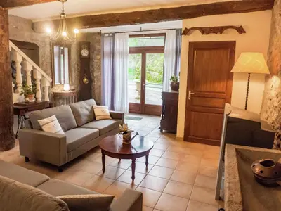 a living room with a couch and a table at Cottage in Montbrun-des-Corbières in Montbrun-des-Corbières