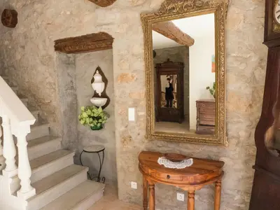 a hallway with a mirror and a wooden table at Cottage in Montbrun-des-Corbières in Montbrun-des-Corbières