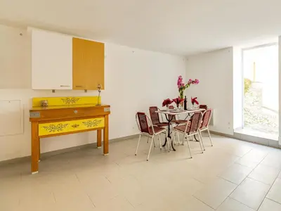 a kitchen and dining room with a table and chairs at Holiday Home in Montouliers near Nature Reserve in Montouliers