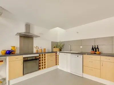 a large kitchen with white cabinets and white appliances at Holiday Home in Montouliers near Nature Reserve in Montouliers