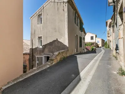 an empty street next to an old building at Holiday Home in Montouliers near Nature Reserve in Montouliers