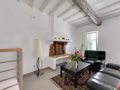 a living room with a couch and a fireplace at Holiday Home in Montouliers near Nature Reserve in Montouliers