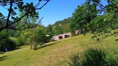 an old building on a hill in a field at The Bergerie in Roquetaillade