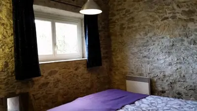 a bedroom with a bed and a window at The Bergerie in Roquetaillade