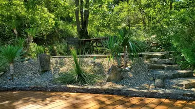 a garden with a bench and some plants at The Bergerie in Roquetaillade
