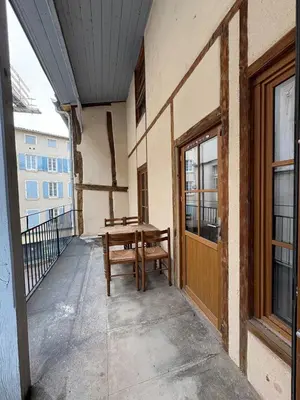 a balcony with a wooden bench on a building at Le Capucin Terrace Hypercentre in Castres