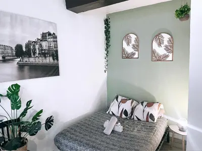 a bedroom with a bed and two pictures on the wall at Appartements hyper Centre in Carcassonne