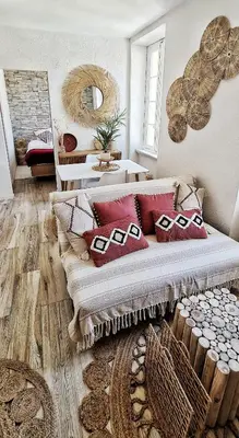 a living room with a couch with pillows on it at N2 Barbacane-Pieds Cité-Bohème Chic-Clim Mobile in Carcassonne