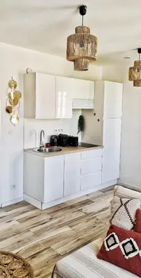 a kitchen with white cabinets and a sink at N2 Barbacane-Pieds Cité-Bohème Chic-Clim Mobile in Carcassonne