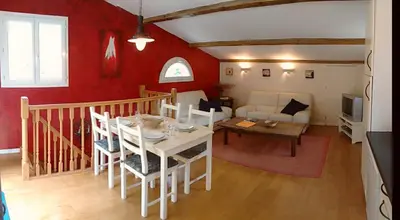 a living room with a table and a couch at The Grange in Roquetaillade