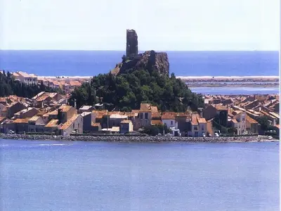 an island in the water with a castle on it at The Studio in Roquetaillade