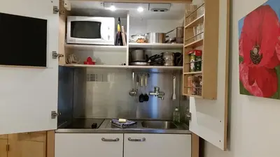 a small kitchen with a sink and a microwave at The Studio in Roquetaillade