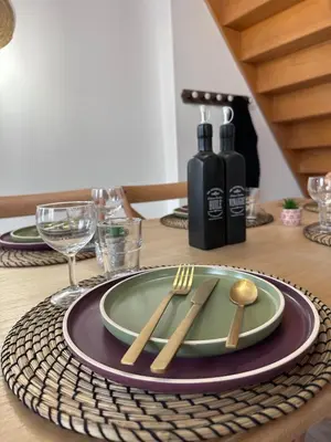 a table with a plate and a fork and knife at House Patio Air Conditioning Elegant Decoration in Carcassonne