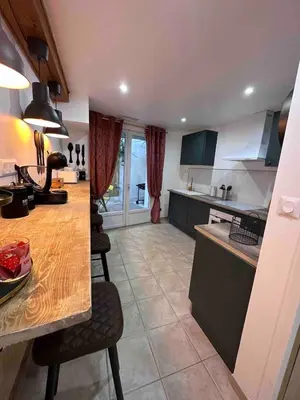 a kitchen with a counter and chairs in a room at House Patio Air Conditioning Elegant Decoration in Carcassonne