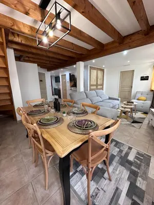 a dining room with a wooden table and chairs at House Patio Air Conditioning Elegant Decoration in Carcassonne