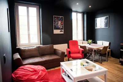 a living room with a couch and a table at Qualys Cinema-Parking & View Square in Carcassonne
