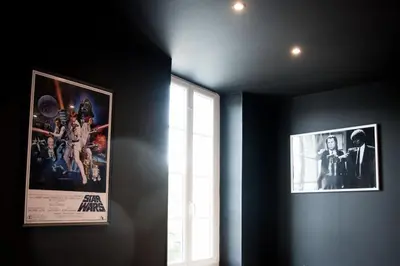 a room with two pictures on the wall and a window at Qualys Cinema-Parking & View Square in Carcassonne
