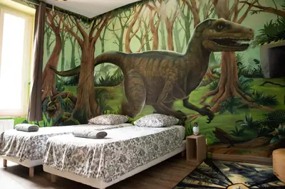 a bedroom with a dinosaur mural on the wall at Qualys Cinema-Parking & View Square in Carcassonne