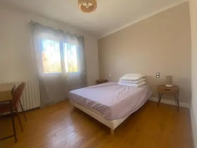 a small bedroom with a bed and a window at Maison Gérard Philippe in Carcassonne