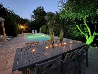 a wooden table with candles in front of a swimming pool at Villa in Saint-Couat with Private Pool in Saint-Couat-dʼAude