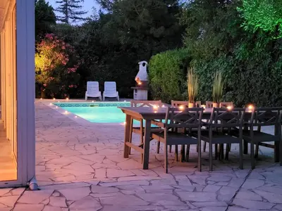 a dining table and chairs with candles on it next to a pool at Villa in Saint-Couat with Private Pool in Saint-Couat-dʼAude