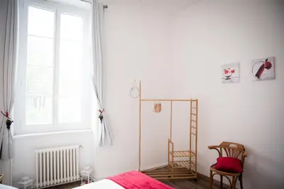 a bedroom with a bed and a window and a chair at Qualys Vignoble parking, square view, close to city in Carcassonne