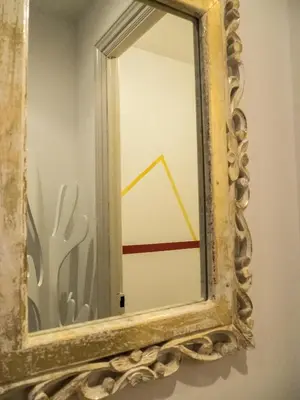 an old mirror with a reflection of a triangle in it at Le Loft De La Robine 110m2 in Narbonne