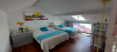 a bedroom with two beds and a window at Le Loft De La Robine 110m2 in Narbonne