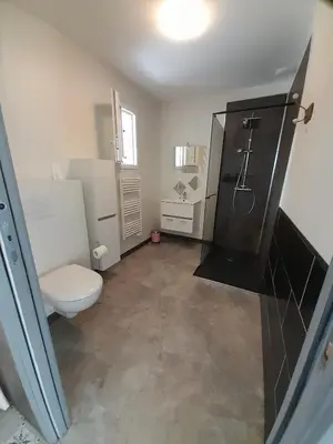 a bathroom with a toilet and a shower and a sink at Chabas Studio in Lagarrigue