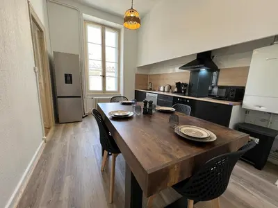 a kitchen with a large wooden table and chairs at L'Excellence, Joli T3 Bourgeois in Carcassonne