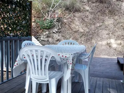 a white table and chairs on a deck at Mobil-Home avec Jacuzzi pour 4 personnes et Terrasse - API-1-52-465 in Sournia
