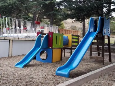 a playground with a slide in a park at Mobil-Home avec Jacuzzi pour 4 personnes et Terrasse - API-1-52-465 in Sournia