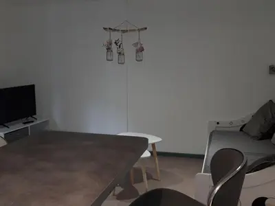 a living room with a table and a couch at Mobil-Home avec Jacuzzi pour 4 personnes et Terrasse - API-1-52-465 in Sournia