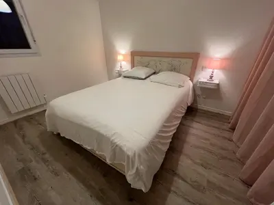 a bedroom with a large white bed with two lamps at Le Parc! T3 climatisé, Parking, Piscine in Carcassonne