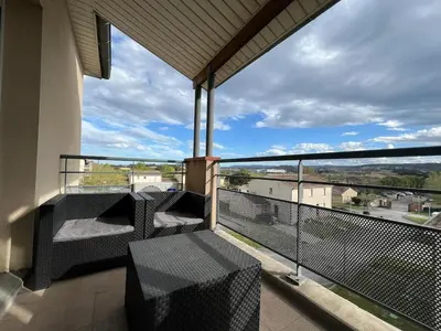a balcony with chairs and a view of the city at Le Parc! T3 climatisé, Parking, Piscine in Carcassonne