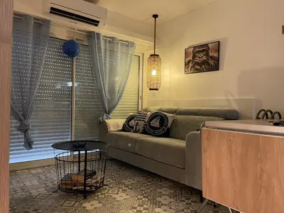 a living room with a couch and a table at Joli Appt Port la Nouvelle in Port-la-Nouvelle