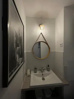 a bathroom with a sink and a mirror at Joli Appt Port la Nouvelle in Port-la-Nouvelle