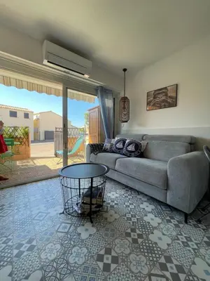 a living room with a couch and a table at Joli Appt Port la Nouvelle in Port-la-Nouvelle