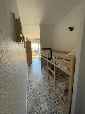 a room with two bunk beds and a hallway at Joli Appt Port la Nouvelle in Port-la-Nouvelle