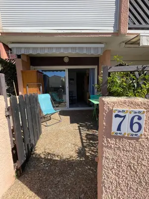 a house with a sign on the front of it at Joli Appt Port la Nouvelle in Port-la-Nouvelle