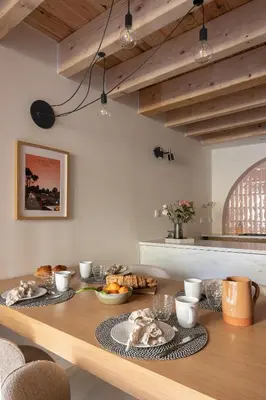 a kitchen with a wooden table with food on it at La Parenthèse Naillousaine in Nailloux