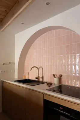 a kitchen with a sink and a brick wall at La Parenthèse Naillousaine in Nailloux