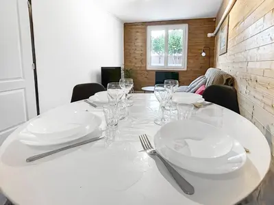 a white table with plates and silverware on it at Terrasse, parking & confort au cœur de Carcassonne in Carcassonne