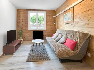a living room with a couch and a table at Terrasse, parking & confort au cœur de Carcassonne in Carcassonne