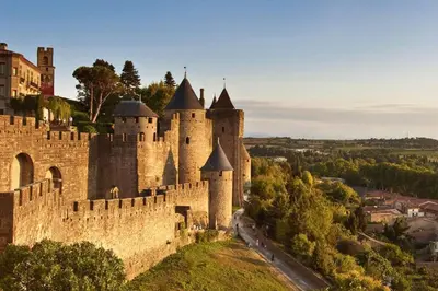 an old castle with turrets on a hill at Terrasse, parking & confort au cœur de Carcassonne in Carcassonne