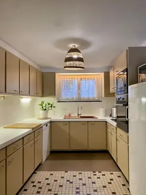 a kitchen with yellow cabinets and a sink at Gîte Massibel au coeur de Brassac in Brassac