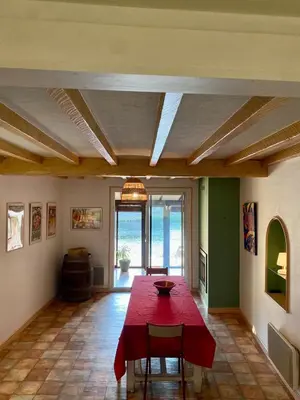 a dining room with a red table and chairs at Gîte Massibel au coeur de Brassac in Brassac