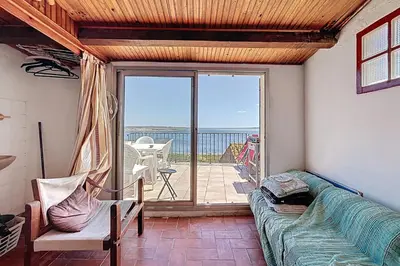a living room with a couch and a view of the ocean at Charming house with terrace and breathtaking views in Bages