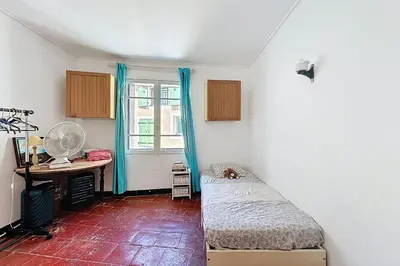a bedroom with a bed and a desk and a window at Charming house with terrace and breathtaking views in Bages